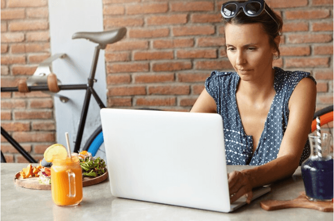 A young girl is working with her laptop.