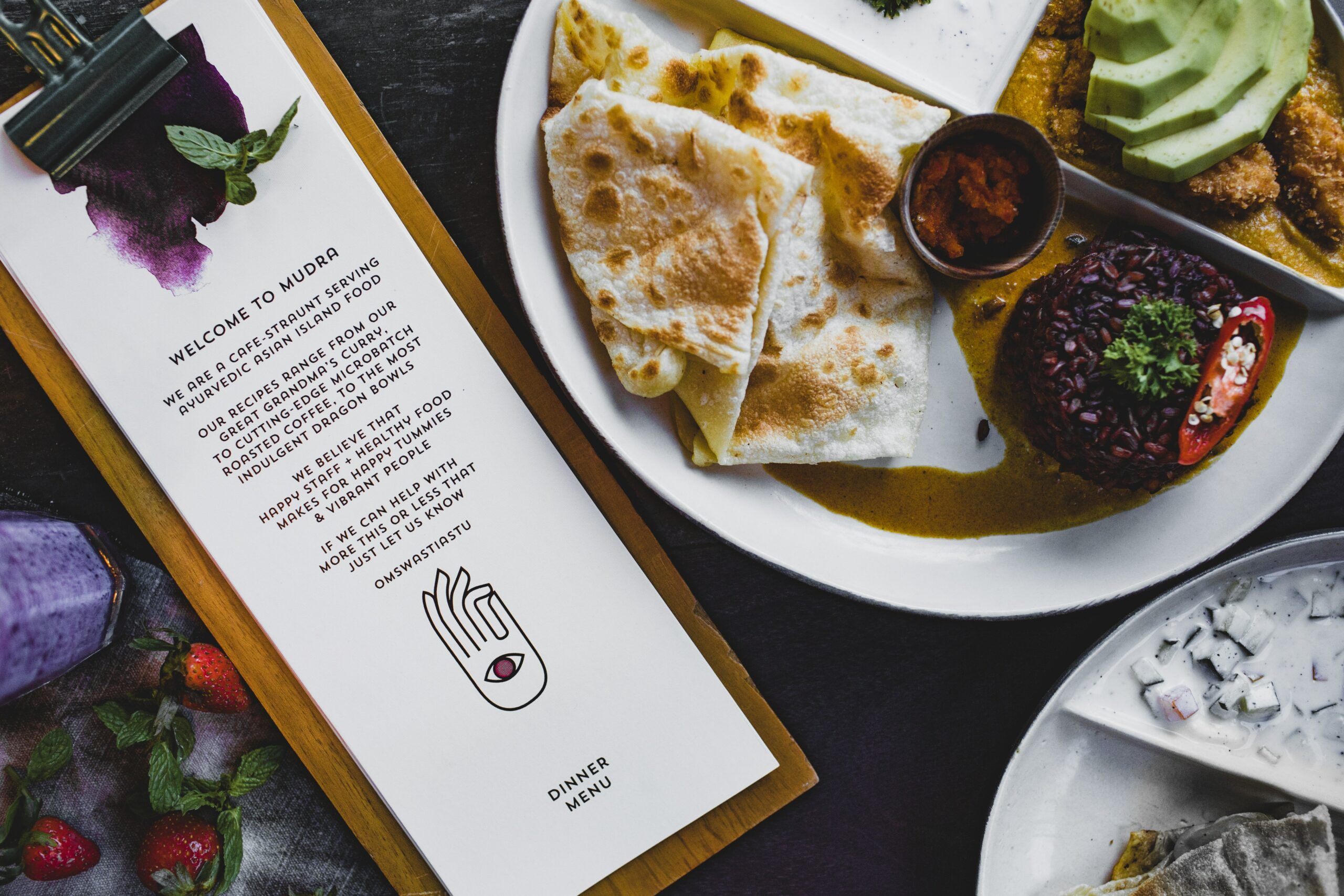 A breakfast with a menu placed on the table.