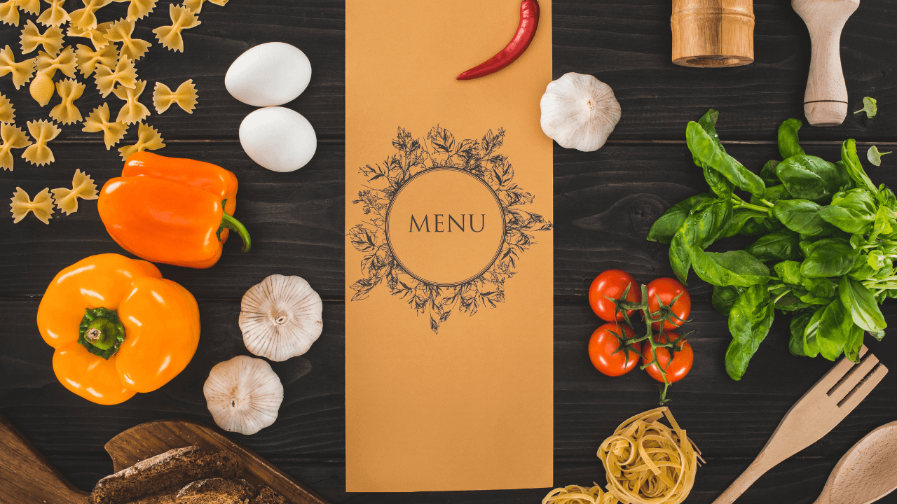 A restaurant menu placed on the table with different vegetables.