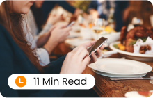 A group of people having lunch and surfing on their mobile phones.