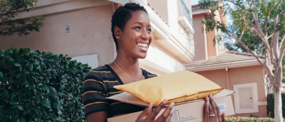 A young girl smilingly hold her orders.