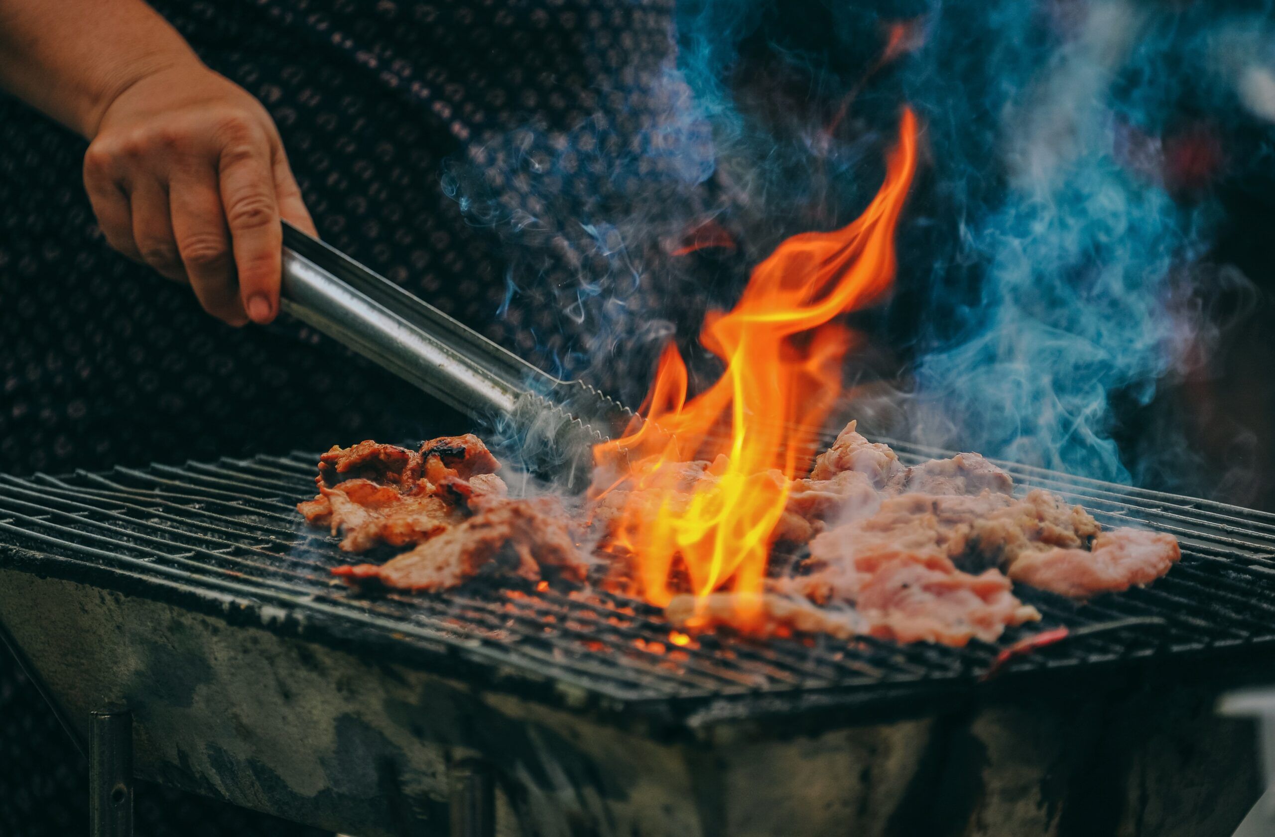 Someone fries meat on the grill.