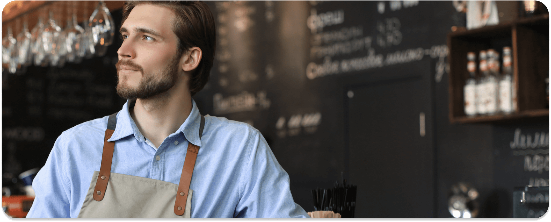 A waiter with an apron is starring somewhere.