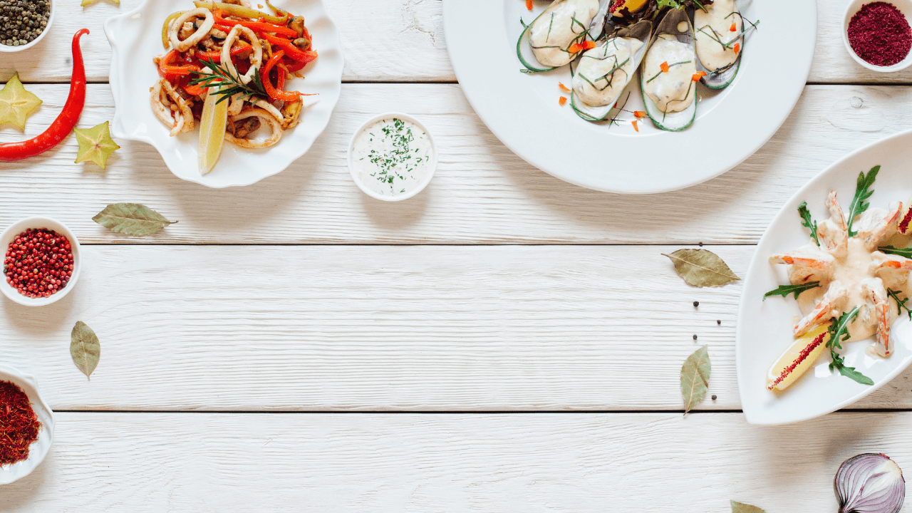 Seafood dishes are placed on the table next to each other.