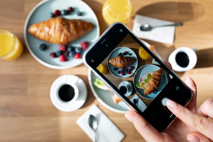 Someone takes a picture of two croissants.