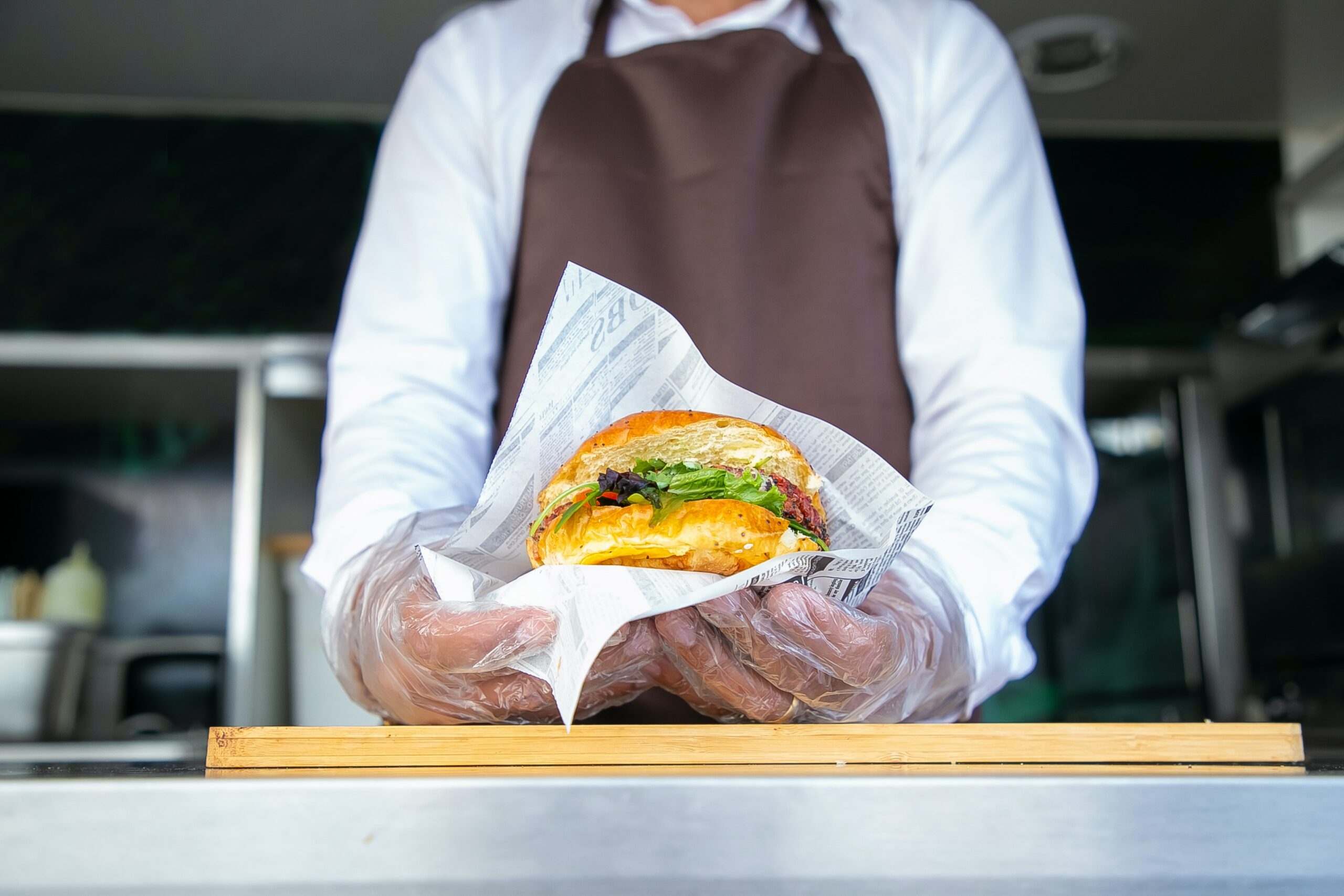 A waiter holds a burger.