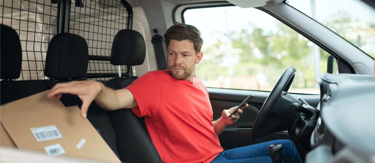 A delivery guy sitting in the car.