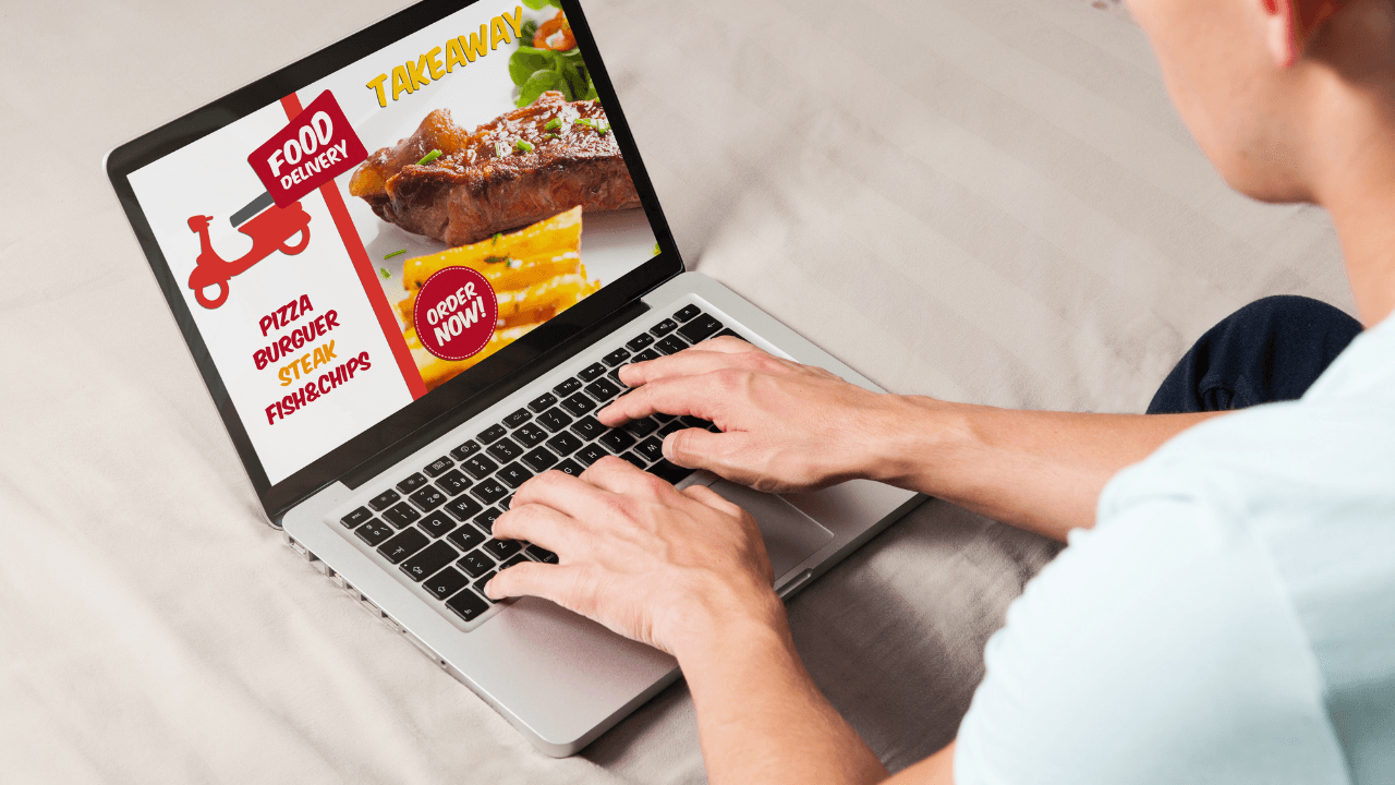 A people is surfing on quick service restaurant menu with his laptop.