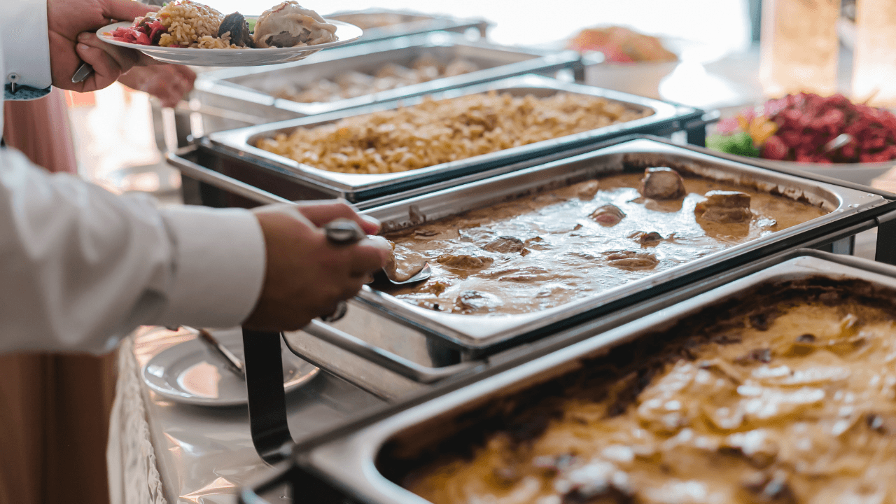 A person helps himself from the catering set.