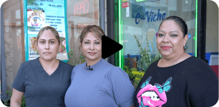 Three middle-aged women are looking at the camera.