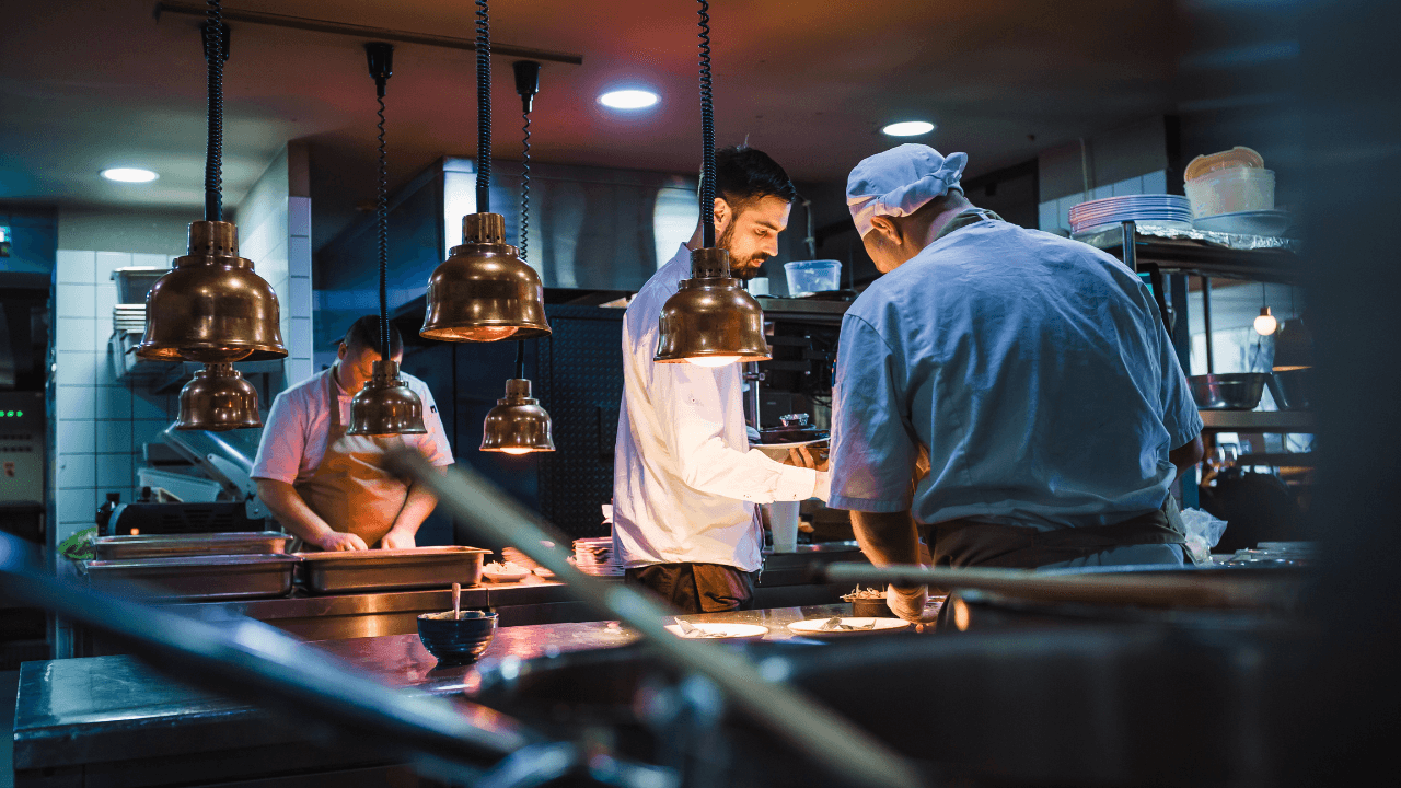 Three cooks are working in the kitchen.