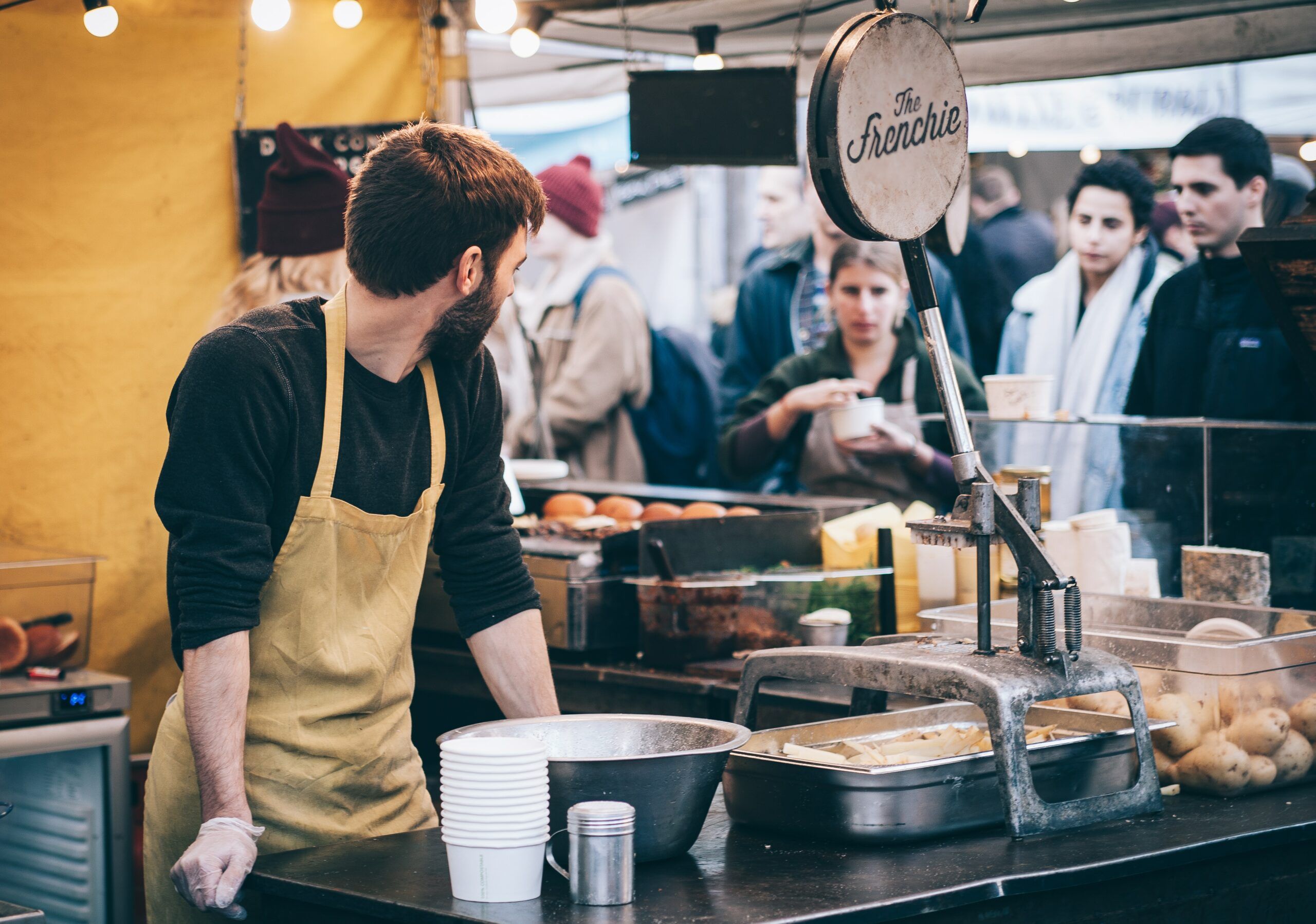 A waiter is looking at the customers.