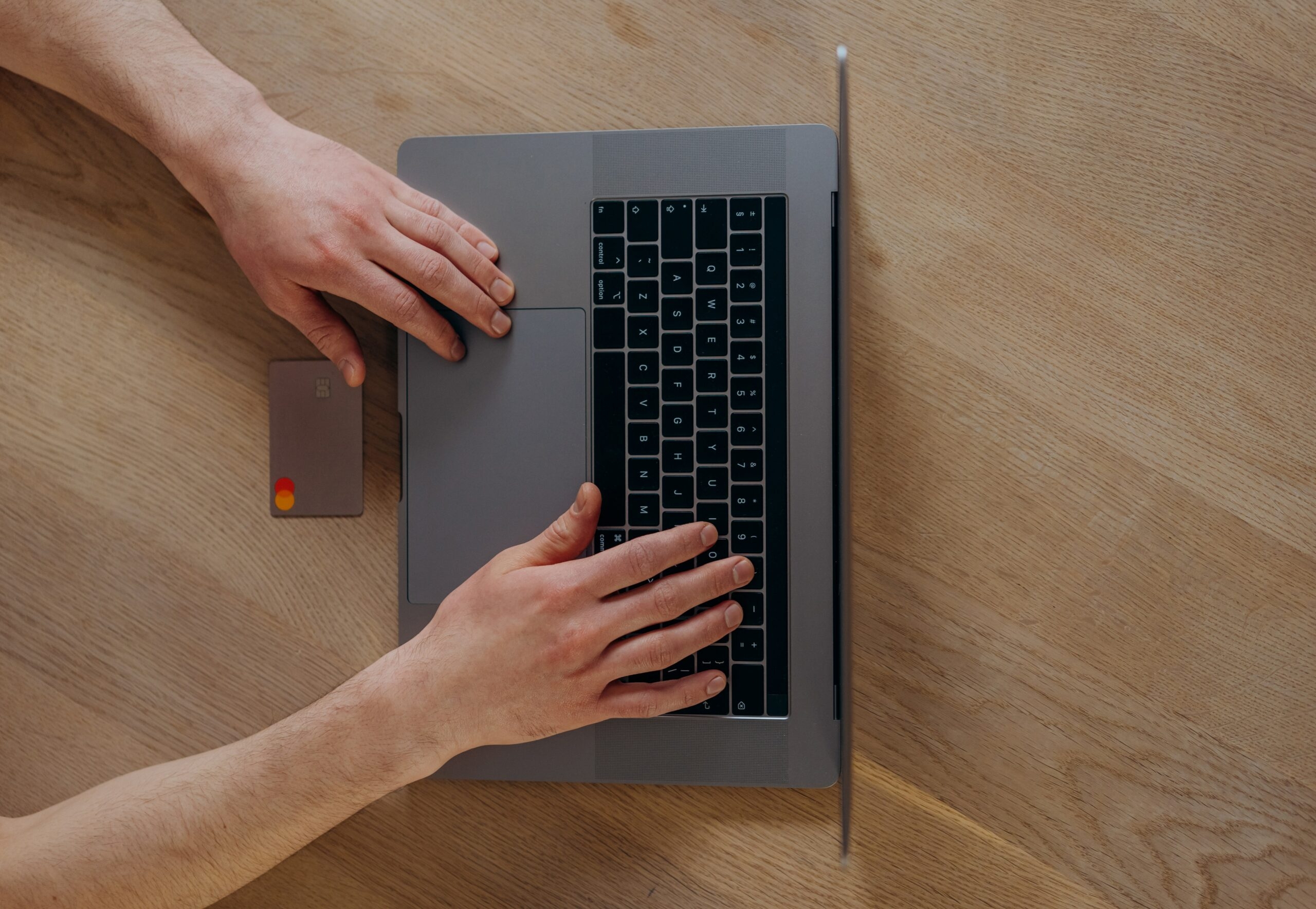 A person is working with his MacBook.