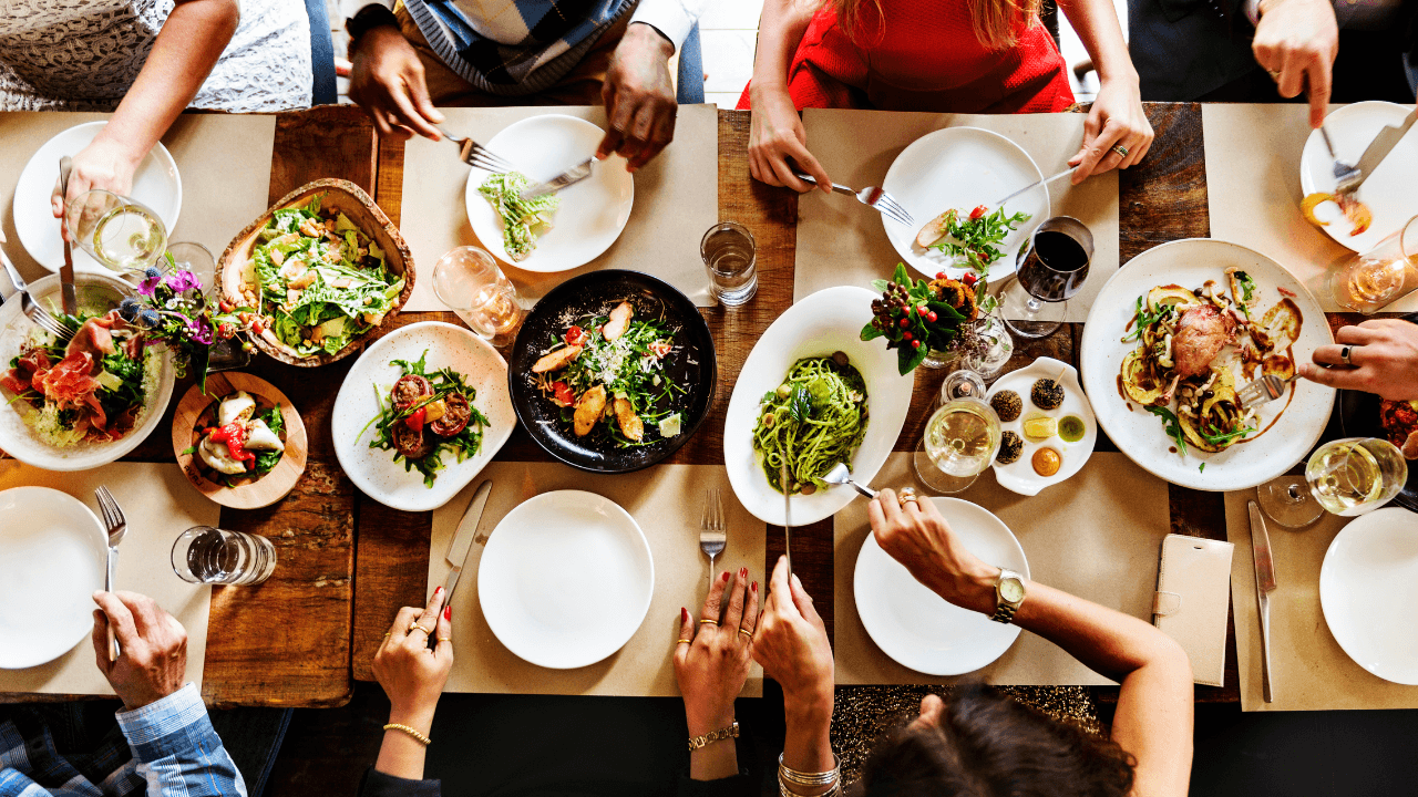 A group of people are having a lunch in the restaurant.