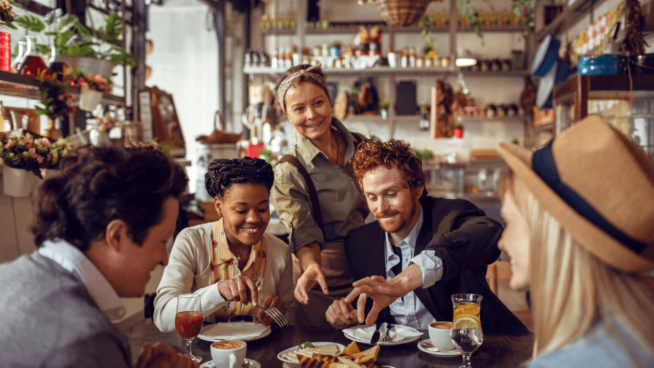 A group of people having a lunch in the restaurant.